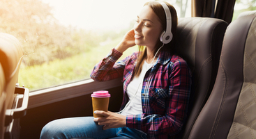 Woman listening to headphones on bus