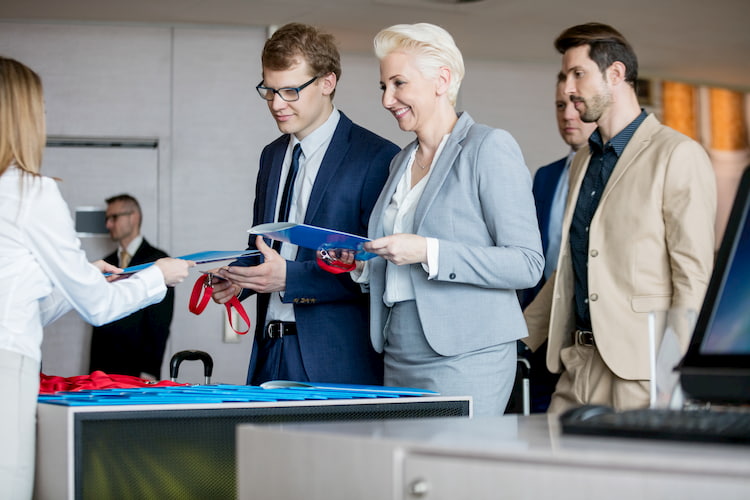 a group of corporate event attendees check in